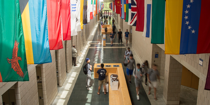 fuqua daytime mba students in the hallway with flags